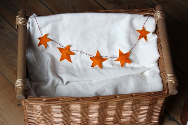Homemade orange peel star garland in a Christmas hamper