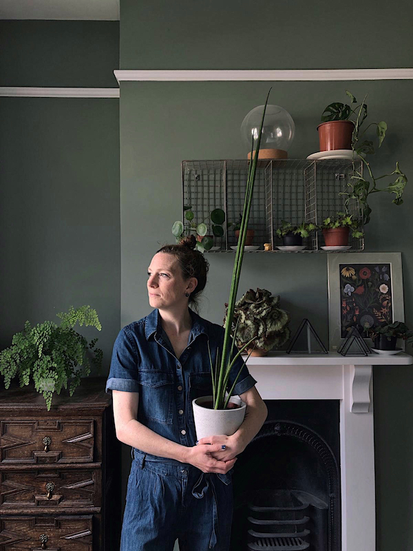 woman holding a houseplant